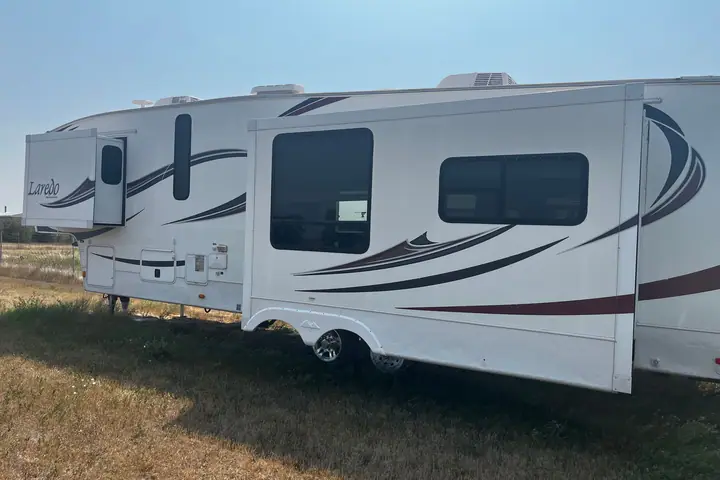 2011 Keystone Laredo 310RE 5th Wheel 3 Slides on the lot at Signature Auto Sales.