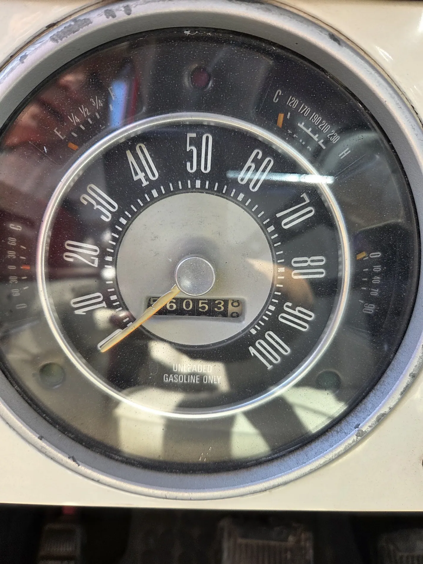 The needle of an old speedometer resting near sixty, with 60,653 on the odometer below it.